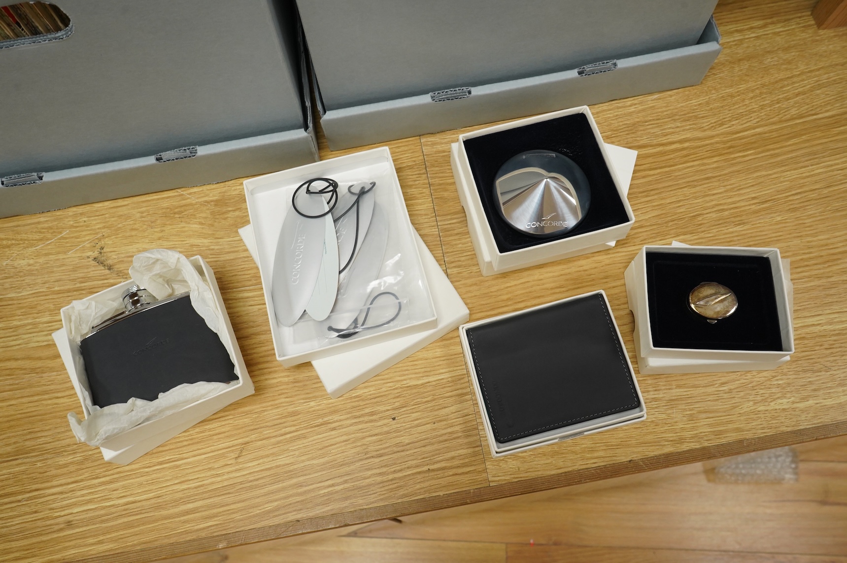 Five boxed British Airways Concorde branded promotional items including; a sterling silver trinket box by Links of London, a hip flask, a bottle opener, a leather credit card holder, and three unused luggage labels